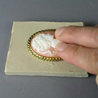 Cameo Broach Placed on Sheeted Safe-D-Clay for Mold Making