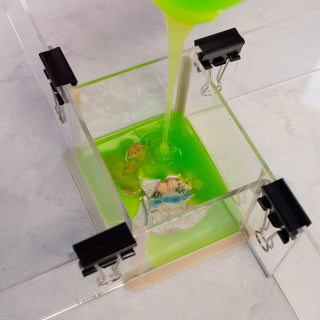 CopyFlex Being Poured Over an Object Mounted and Contained in an Adjusta-Mold Mold Box