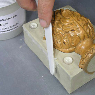 Applying Mold-Dit to the Side of a Clay Bed for Mold Making