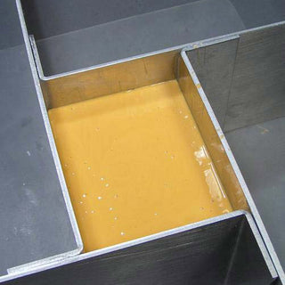 Liquid Food Grade Silicone Poured Over a Master Mounted in a Mold Box