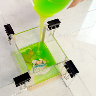CopyFlex Food Grade Liquid Silicone Being Poured Over a Model Mounted on the Bottom of a Mold Box