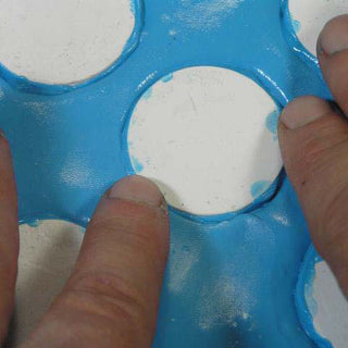 Pressing Objects into a Bed of Silicone Plastique to Make a Multiple Cavity Mold